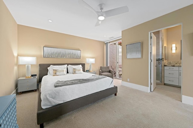 carpeted bedroom featuring ensuite bath and ceiling fan