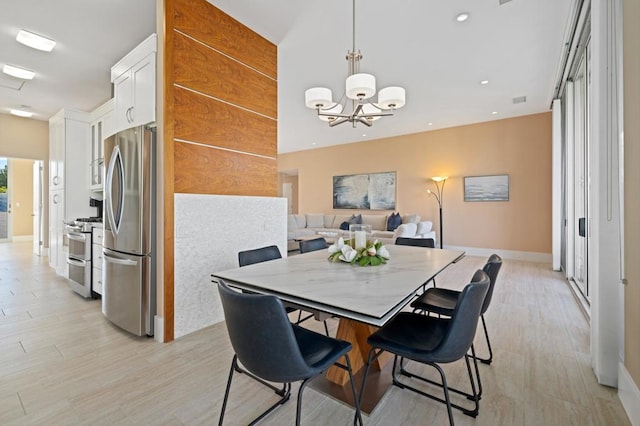 dining room featuring a chandelier and light hardwood / wood-style flooring