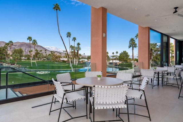 view of patio featuring a mountain view and ceiling fan