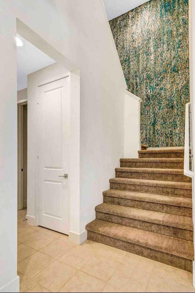 staircase featuring tile patterned floors