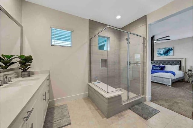 bathroom featuring vanity, a shower with shower door, and tile patterned floors