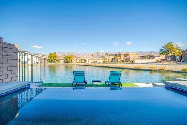 view of pool featuring a water view