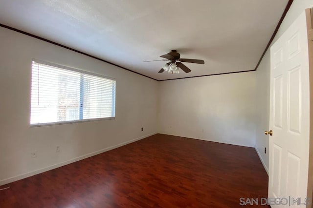 unfurnished room featuring ceiling fan, ornamental molding, and dark hardwood / wood-style floors