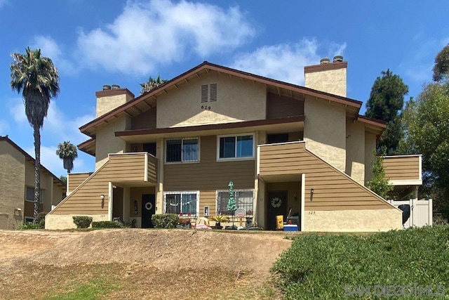 rear view of property with a balcony