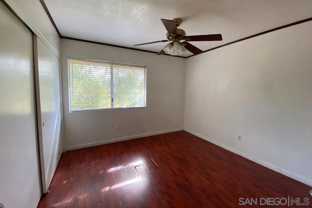 spare room featuring ornamental molding, dark hardwood / wood-style floors, and ceiling fan