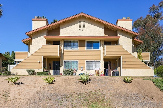 rear view of property featuring a balcony