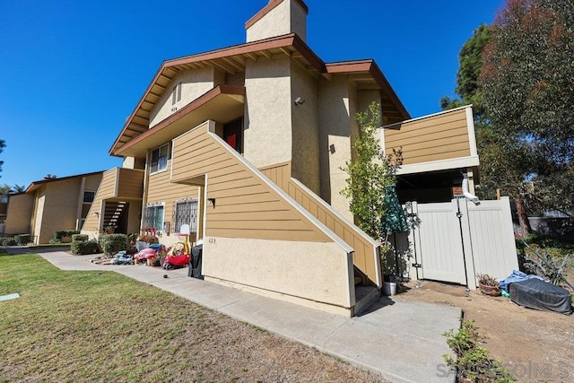 rear view of property featuring a lawn