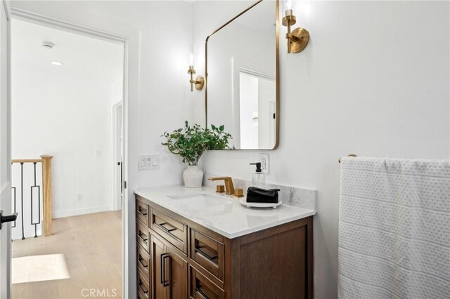 bathroom with vanity and hardwood / wood-style flooring