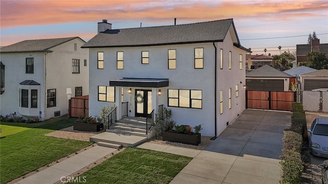 multi unit property featuring stucco siding, a yard, a chimney, and a gate