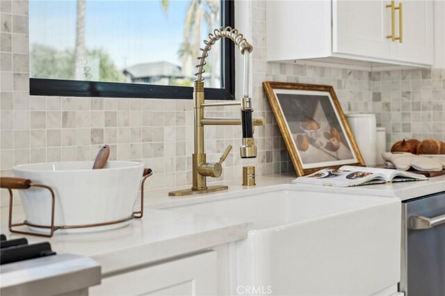 details with dishwasher, white cabinets, and decorative backsplash