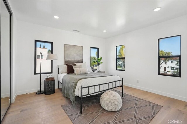 bedroom with light hardwood / wood-style floors