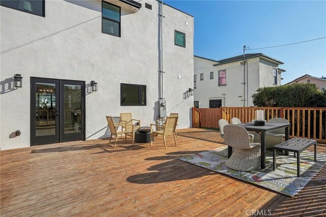 deck featuring french doors and an outdoor fire pit