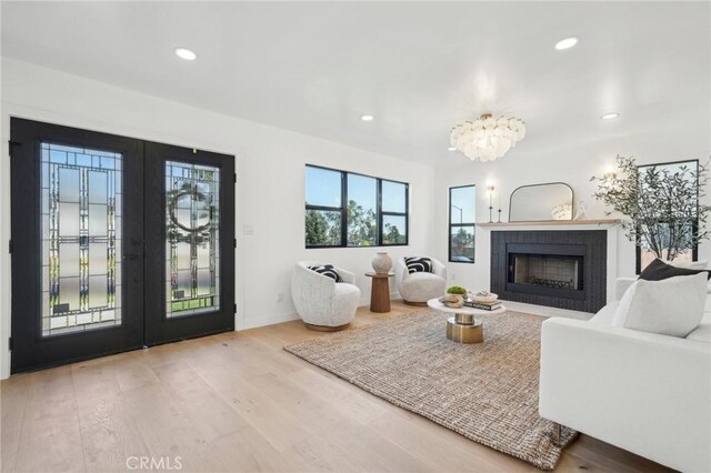 living room with french doors and light hardwood / wood-style floors