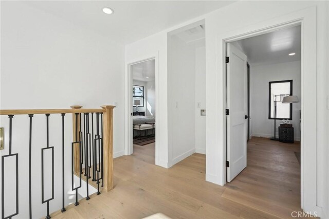 corridor with light hardwood / wood-style floors