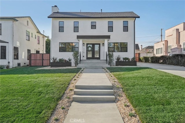 view of front of home with fence, a front yard, stucco siding, french doors, and a chimney