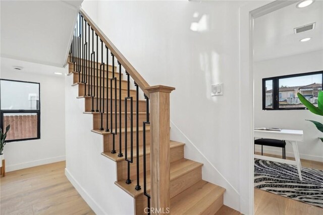 stairway featuring hardwood / wood-style flooring