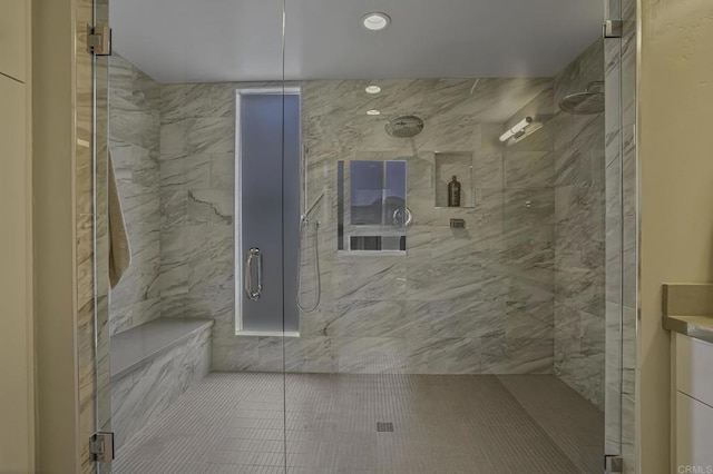 bathroom with a shower with door