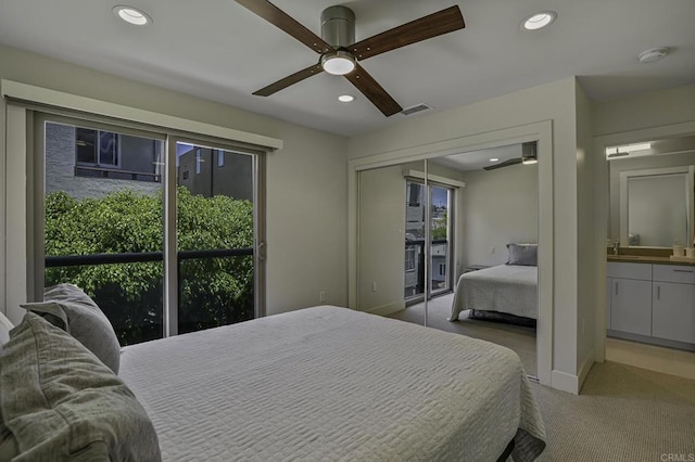 carpeted bedroom featuring ceiling fan, a closet, and multiple windows