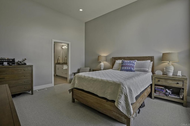 carpeted bedroom featuring ensuite bathroom