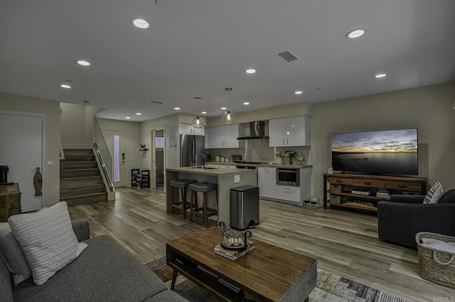 living room with light hardwood / wood-style flooring