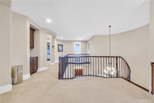 hallway with light colored carpet