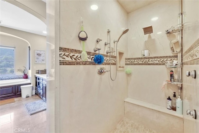 bathroom with independent shower and bath, vanity, and tile patterned floors