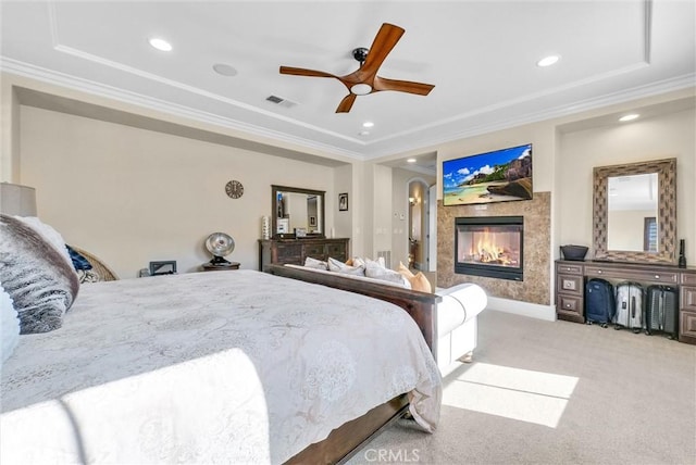 carpeted bedroom featuring ornamental molding and ceiling fan