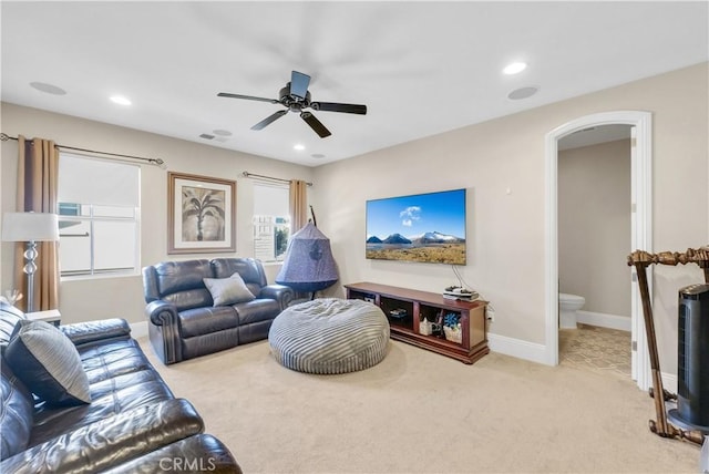 carpeted living room featuring ceiling fan