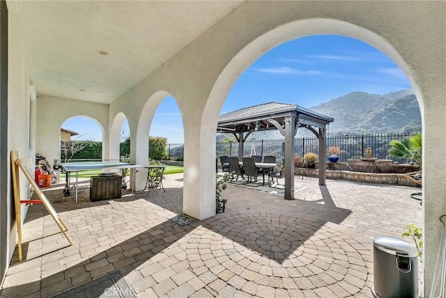 view of patio featuring a gazebo and a mountain view