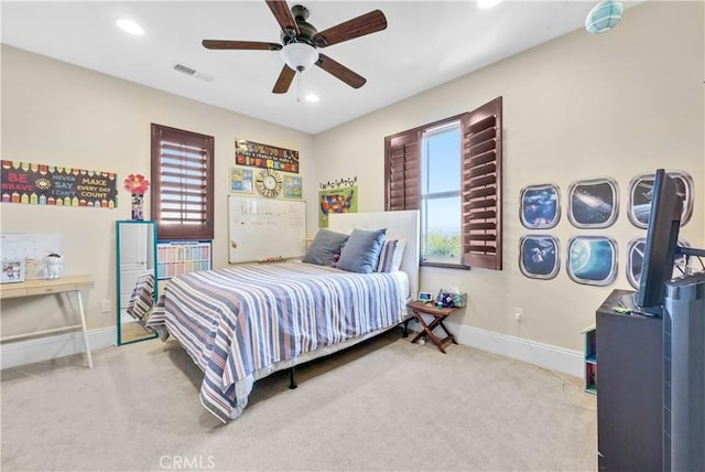 bedroom with ceiling fan and light colored carpet