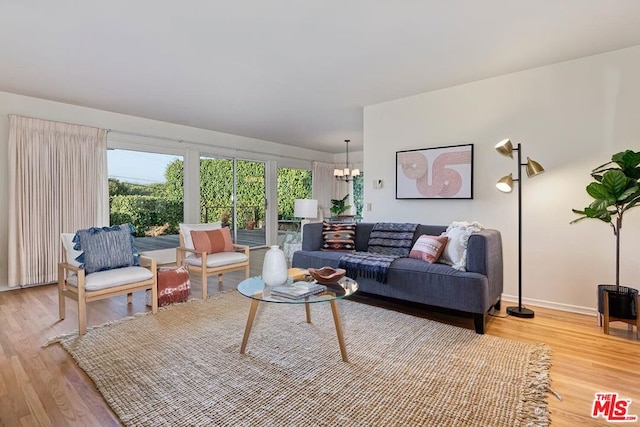 living room with hardwood / wood-style flooring and a notable chandelier