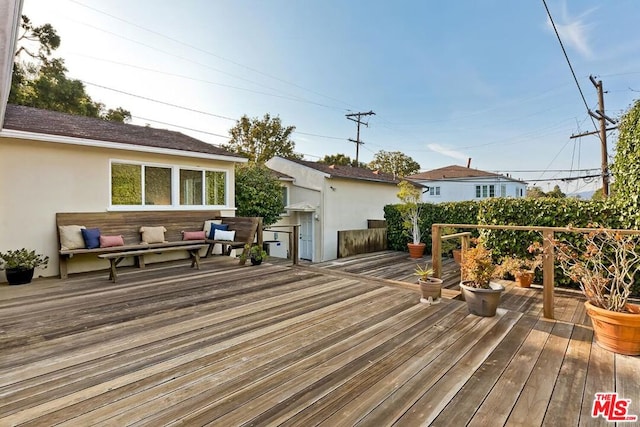 wooden deck featuring outdoor lounge area