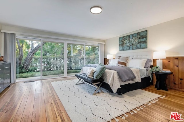 bedroom featuring access to exterior and light hardwood / wood-style floors