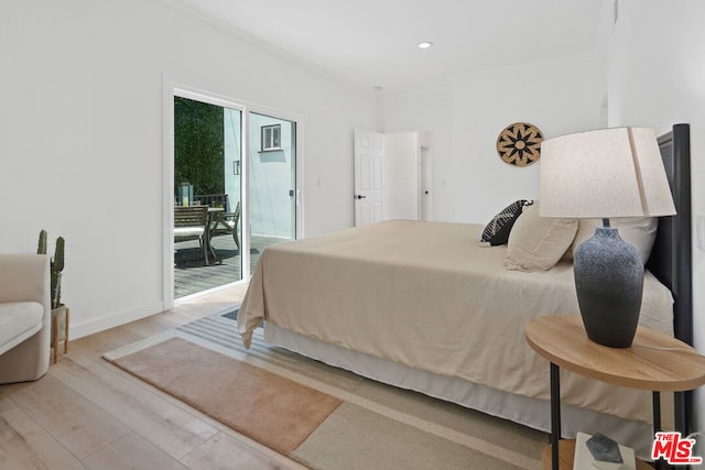 bedroom featuring crown molding, access to exterior, and light hardwood / wood-style floors