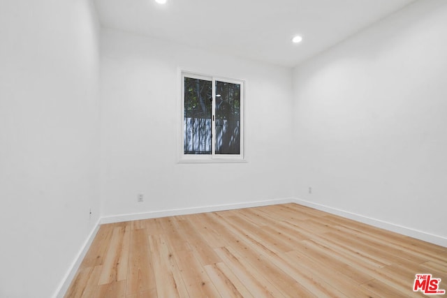 spare room with light hardwood / wood-style floors