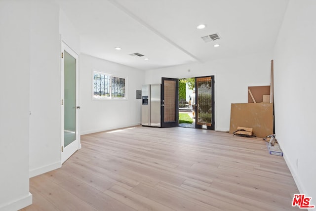 unfurnished room with plenty of natural light and light hardwood / wood-style floors