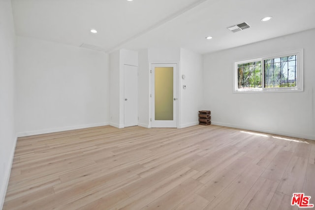 spare room featuring light hardwood / wood-style floors