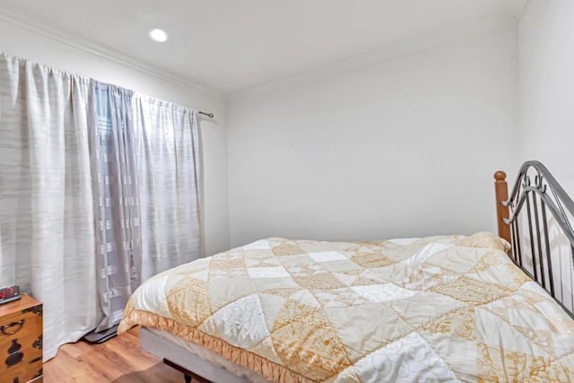 bedroom featuring hardwood / wood-style flooring and ornamental molding