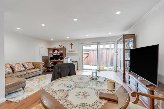 living room with light hardwood / wood-style flooring and ornamental molding