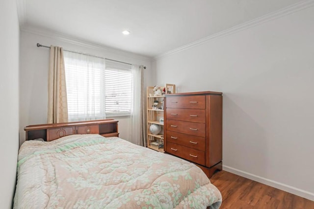 bedroom featuring ornamental molding and hardwood / wood-style floors