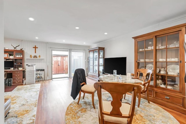 living room featuring crown molding and light hardwood / wood-style flooring