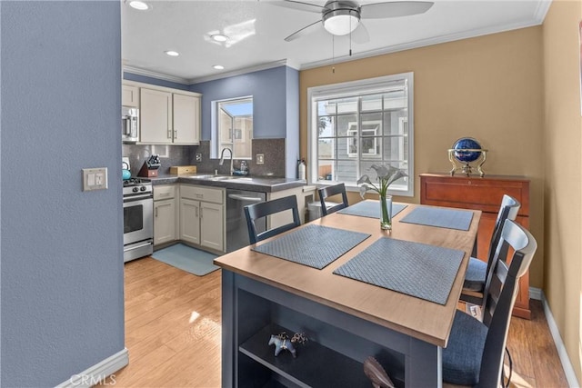 dining room featuring crown molding, sink, ceiling fan, and light hardwood / wood-style floors