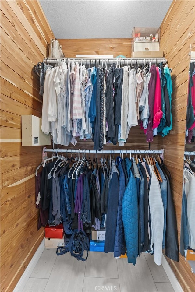 walk in closet with light tile patterned flooring