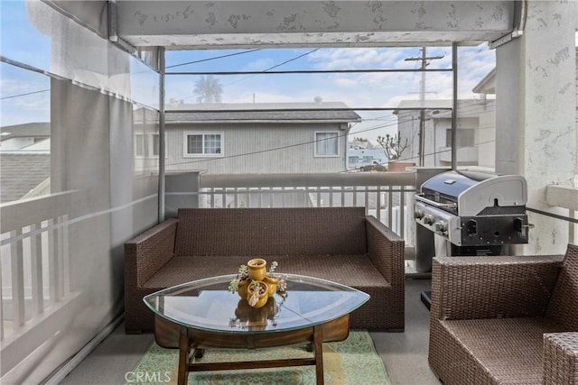 balcony with area for grilling and an outdoor living space