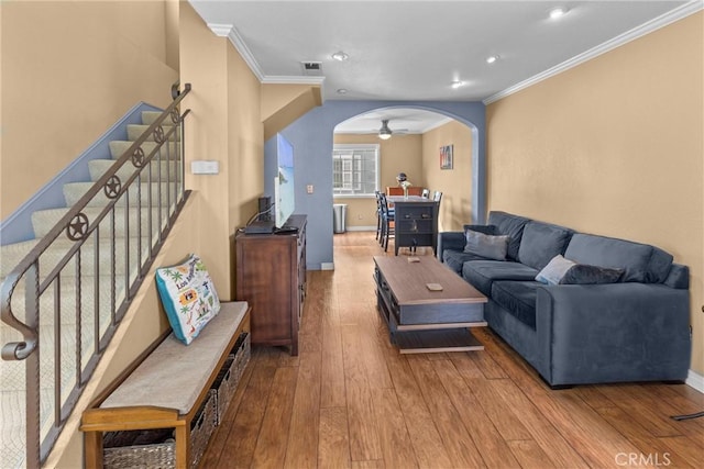 living room featuring hardwood / wood-style flooring and crown molding