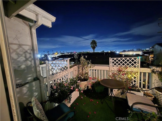 view of balcony at twilight