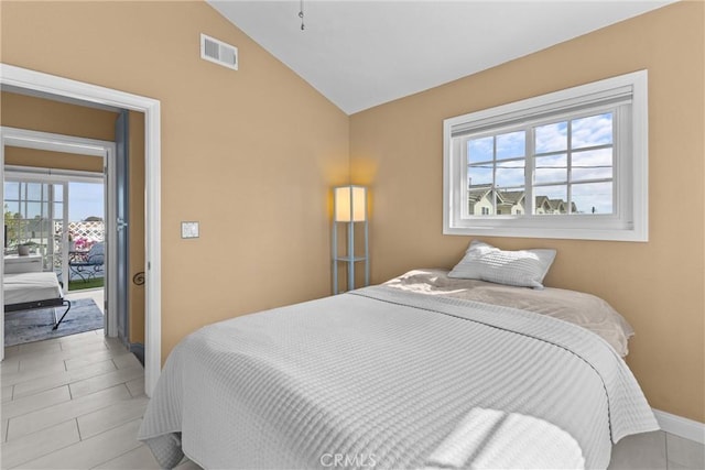 tiled bedroom featuring lofted ceiling