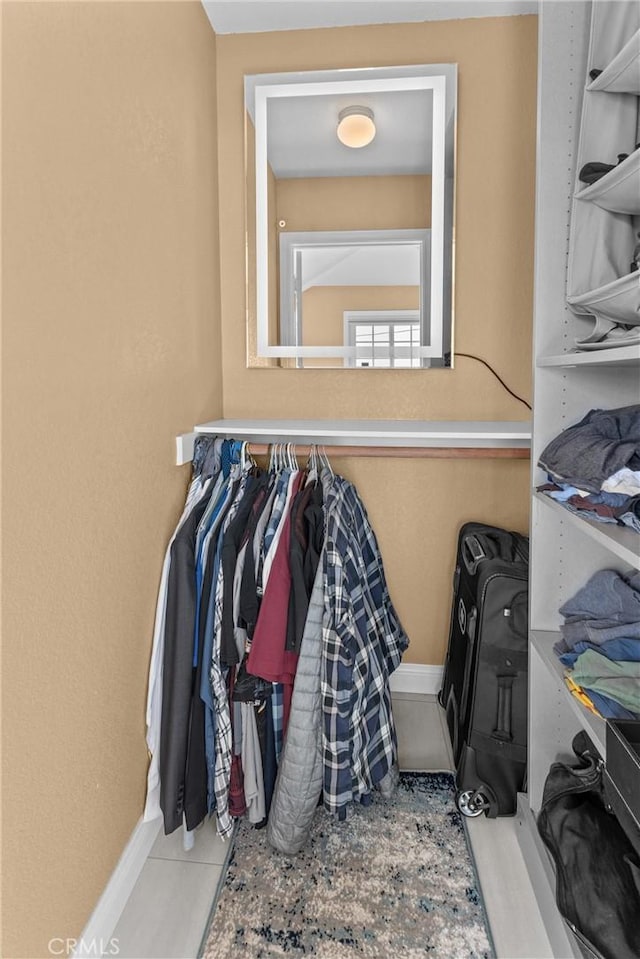 walk in closet featuring light tile patterned floors