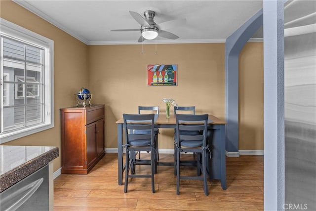 dining space with ornamental molding, ceiling fan, and light hardwood / wood-style floors