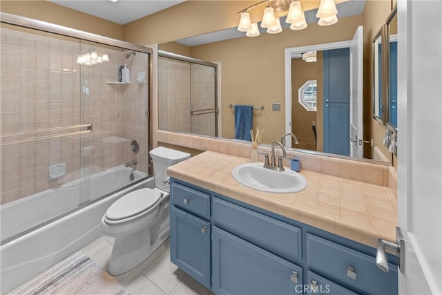 full bathroom featuring vanity, bath / shower combo with glass door, tile patterned floors, and toilet